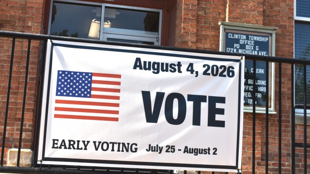 A banner outside the Clinton Township Hall invites residents to vote in the Aug. 4 primary election.